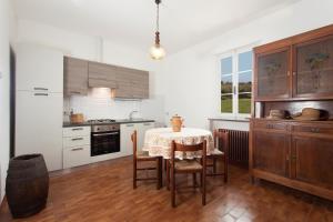 a kitchen with a table and a table and chairs at La Fattoria in Santarcangelo di Romagna