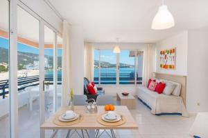 a living room with a couch and a table at Apartamentos Calablanca in Palmanova