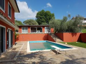 a swimming pool in a yard next to a house at IL CICLAMINO POOL FOR YOUR SOLE USE BIG IN-GROUND - 70m2 house & 300m2 outdoor, child & pet friendly, 10 minutes drive to Montebello Station connecting to Rome centre in 20 minutes, 3 minutes drive to supermarket -4 language warm guest care in Riano