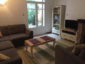 a living room with a couch and a coffee table at Maison les Ramparts in Villefranche-de-Conflent