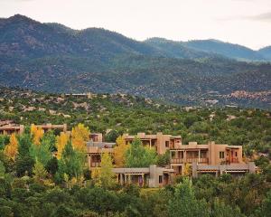 a group of houses on a hill with mountains at Four Seasons Resort Rancho Encantado Santa Fe in Santa Fe