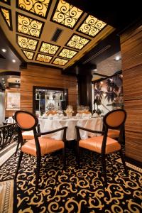 a dining room with a table and two chairs at Hotel Odissey Jaz in Budva