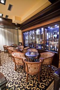 a restaurant with tables and chairs and a bar at Hotel Odissey Jaz in Budva