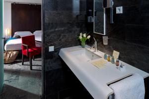 
a bathroom with a sink and a bathtub at Hotel Boutique Ses Pitreras in Port des Torrent
