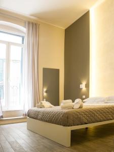 Кровать или кровати в номере La Banchina Holiday Rooms