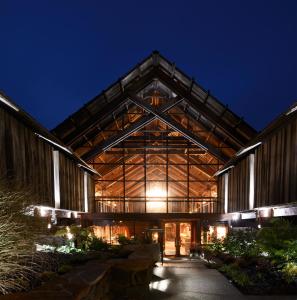 a large building at night with the lights on at Timber Cove Resort in Jenner