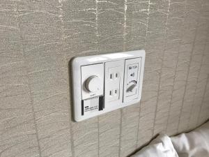 a electrical outlet on the wall of a bedroom at Sumiya Spa & Hotel in Hiroshima