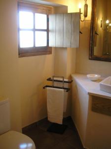 a bathroom with a toilet and a sink and a window at Casa da Silveirinha in Marvão +19 photos