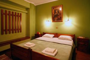 a bedroom with a bed with two towels on it at Morfi Hotel in Kerkini