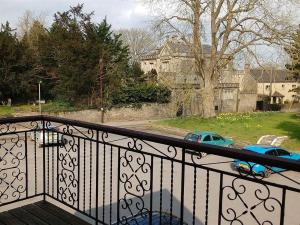 a balcony with a view of a house and a car at The Bell House in Sutton Benger