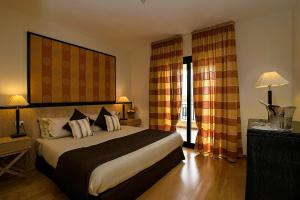 Postel nebo postele na pokoji v ubytování Mahara Hotel & Wellness