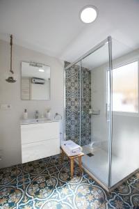 a bathroom with a shower and a sink at Lukanda Arenal in Seville