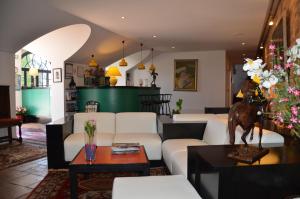 a living room with a couch and a table at Hotel des Mimosas in Juan-les-Pins