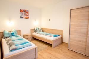 a bedroom with two beds and a mirror at Sándor Apartman in Balatonfüred +20 photos