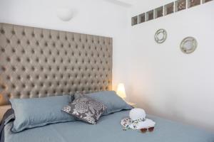 a bedroom with a bed with a tufted headboard at Daedalus Hotel in Fira