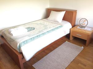 Giường trong phòng chung tại Apartamento Praia Azul