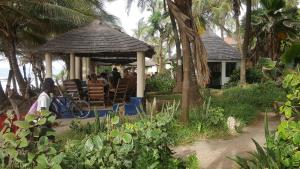 a gazebo with a table and chairs on the beach at Leybato Beach Hotel in Fajara