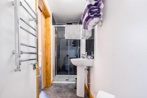 a bathroom with a sink and a shower at Lazy Days in Whitby +19 photos