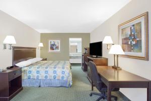 a hotel room with a bed and a desk at Super 8 by Wyndham Corpus Christi in Corpus Christi
