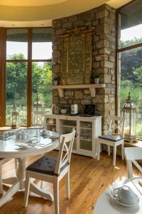 a kitchen with a table and chairs and a stone wall at Down Yonder Boutique B&B in Sligo