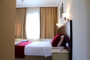 a hotel room with a bed and a window at Dove Apart Hotel in Fethiye