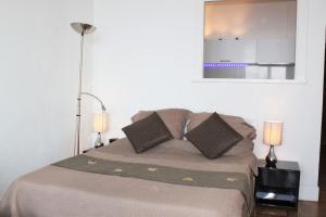 a bedroom with a bed with two lamps and a mirror at Beachfront apartment Promenade Des Anglais in Nice +27 photos