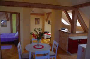 a room with a table with a vase of flowers on it at Apartment Tomy in Slunj