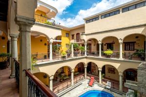 
a large building with a pool and a balcony at Hotel CasAntica in Oaxaca City
