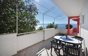 a patio with a table and chairs on a balcony at Apartments Coko in Omiš
