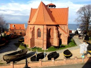 a church with boats in front of it at HelApart - Mesa in Hel +5 photos