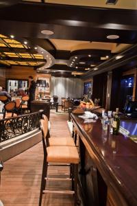 a bar in a restaurant with tables and chairs at Hotel Odissey Jaz in Budva
