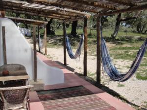 a couple of hammocks under a pergola at Ponte Pedra - Melides Country House Adults Only in Melides