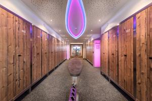 a locker room with wooden walls and a purple light at Hotel Alpenhof Superior in Zauchensee