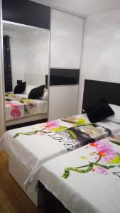 a bedroom with two beds with flowers on them at Apartment Fortuna in Makarska