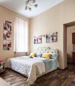 a bedroom with a bed and a window at Queens Apartments in Lviv