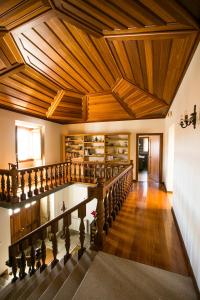 
a large room with wooden floors and a large window at Casa da Fidalga - Villa of 5 bedrooms in Outeiro de Gatos
