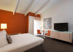 Habitación de hotel con cama y TV de pantalla plana. en Inn at Venice Beach, en Los Ángeles
