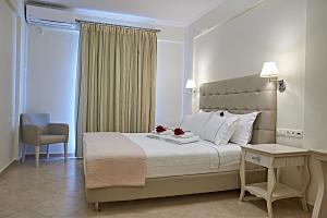 a bedroom with a bed and a desk and a chair at Element Hotel in Elafonisos