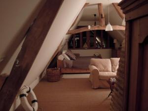 a room with a staircase with a couch and a bed at La Maison De Lalette in Gruchet-Saint-Siméon