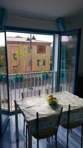 a table with a bowl of fruit on it in front of a window at Casa Vacanze Daniela in Santa Teresa Gallura