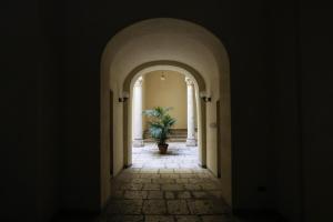 a hallway with a potted plant in a building at Scabi Apartments in Trapani