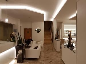 a man sitting on a couch in a living room at Hotel Solemare in Cesenatico