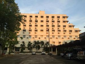 a large building with cars parked in front of it at Paradorn Inn in Chumphon