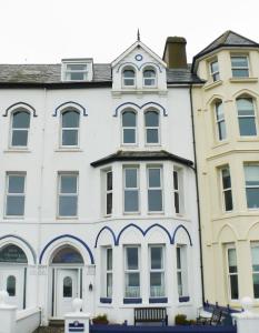 a large white building with a large window at Kittiwake House in Port Erin