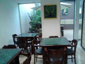 a restaurant with tables and chairs in a room at Mansion Havre in Mexico City