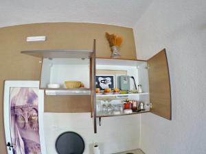 a small kitchen with a shelf in a wall at Studio Jegdic in Trebinje +23 photos