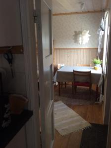 a room with a table and a room with a door at Lillstugan in Älvkarleby