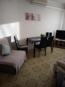 a living room with a dining room table and chairs at Apartment Nonna Maria in Umag
