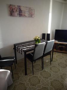 a dining room table with two chairs and a vase of flowers at Apartment Nonna Maria in Umag +3 photos