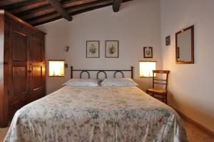 a bedroom with a large bed with two pillows at Casale Giacomini in Manciano